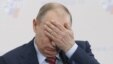 Prime Minister Vladimir Putin covers his face during a conference of the Russian Union of Industrialists and Entrepreneurs in Moscow on February 9.