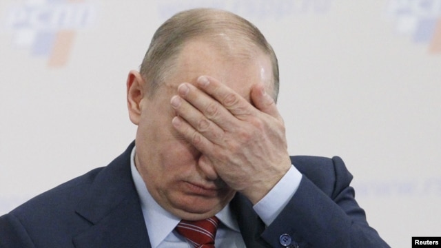 Prime Minister Vladimir Putin covers his face during a conference of the Russian Union of Industrialists and Entrepreneurs in Moscow on February 9.
