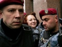 Ukrainian police escort Constitutional Court Justice Syuzanna Stannyk (center) into the court building today (AFP)