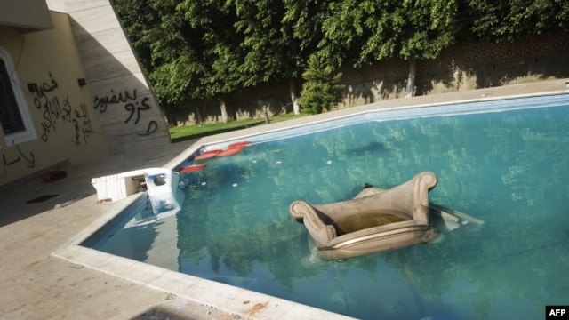 An armchair and furniture float in the swimming pool of the U.S. consulate in Benghazi following an attack on the building in September 11 in which the US ambassador to Libya and three other US nationals were killed. 
