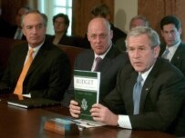 President Bush (right) holding his budget during a cabinet meeting on February 5 (epa)