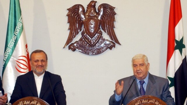Al-Muallim (right) in Damascus with Iranian Foreign Minister Manuchehr Mottaki in May (epa)