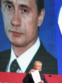 St. Petersburg native and Federation Council Chairman Sergei Mironov in front of a poster of Putin at a political conference in Petersburg last month (TASS)