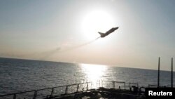 An U.S. Navy picture shows what appears to be a Russian Sukhoi SU-24 attack aircraft flying close to the U.S. guided missile destroyer USS Donald Cook in the Baltic Sea on April 12.