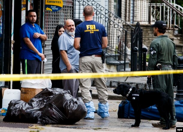 Mohammed Rahami (third from left), the father of Ahmad Khan Rahami, talks with FBI investigators in Elizabeth, New Jersey.