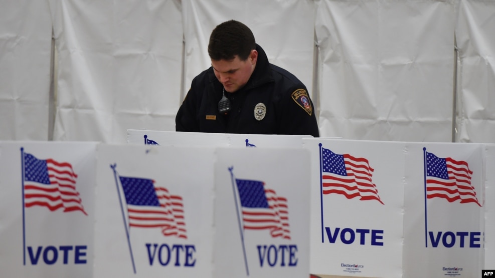 A policeman voting during the presidential primary in New Hampshire in February.