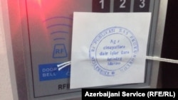 Azerbaijani prosecutors seal shut RFE/RL's Baku bureau after ordering staff to leave during a raid on December 26,2014.