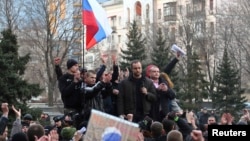Pro-Russian demonstrators take part in a rally in front of the regional government building in Donetsk on March 5.