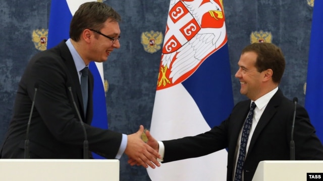 Serbian Prime Minister Aleksandar Vucic (left) and Russian Prime Minister Dmitry Medvedev shake hands at a press conference in Moscow on July 7.