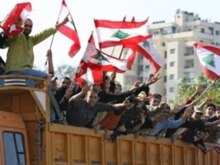 Lebanon - Lebanese wave their national flags as they arrive on board of a truck to take part in a demonstration by opposition groups, Beirut, 01Dec2006