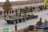A screen grab of Turkmen television showing Niyazov's funeral in December and is portrait in the upper right corner (AFP)