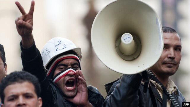Antigovernment protesters shout slogans outside the Egyptian parliament.