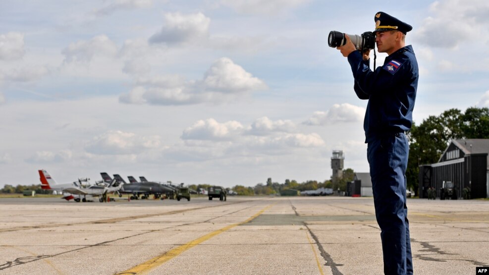 A Russian Air Force officer takes photos of the joint Russian-Serbian military exercises at an airport in Batajnica, near Belgrade, on October 13.