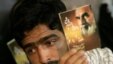 A man in 2007 holds a portrait of Ayatollah Ruhollah Khomeini during a memorial ceremony to mark the 18th anniversary of Khomeini