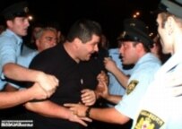 A protester confronts police yesterday in Tbilisi