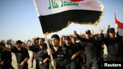 Fighters loyal to Shi'ite cleric Muqtada al-Sadr march during a military-style training drill in the holy city of Najaf.