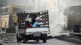 Syria -- A family on a pick-up truck flees violence in the city of Aleppo, 17Oct2012