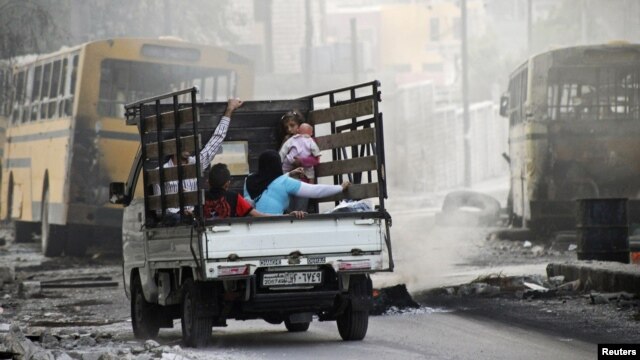 Syria -- A family on a pick-up truck flees violence in the city of Aleppo, 17Oct2012