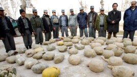 Police inspect piles of heroin discovered during an operation in Herat, Afghanistan