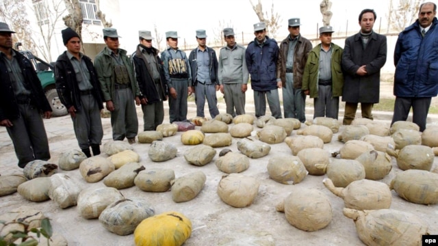 Police inspect piles of heroin discovered during an operation in Herat, Afghanistan