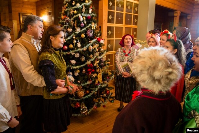 Ukrainian President Petro Poroshenko and his wife, Maryna, meet with Christmas singers in the Ivano-Frankivsk region of western Ukraine.