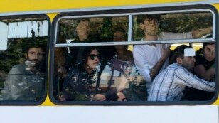 Gay-rights activists look out from a bus as they are evacuated by police during clashes in Tbilisi on May 17.
