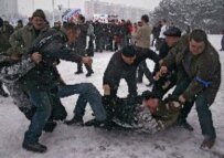 Supporters of President Alyaksandr Lukashenka seize an opposition supporter at an opposition rally in Brest on March 11 (epa)