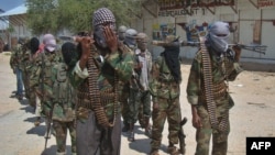 Al-Shabab recruits walk down a street in the Deniile district of Mogadishu in March 2012.