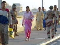 Pedestrians and military personnel walking over a bridge in Baghdad's Green Zone (file photo) (AFP)