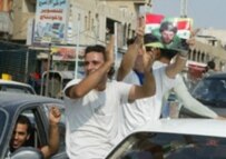 Iraqis in a predominately Shi'ite Baghdad suburb celebrate the verdict (AFP)