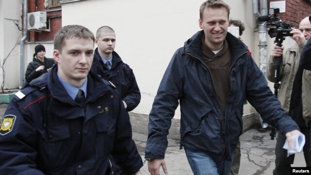 Prominent anticorruption blogger Aleksei Navalny (right) arrives for an appeal hearing at a court in Moscow on December 7. Has the Kremlin made him into an opposition icon by arresting him?