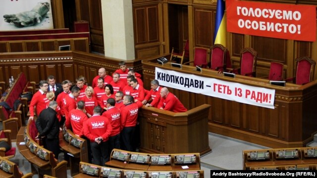 Ukrainian opposition politicians have occupied the parliament's podium for more than two weeks. 