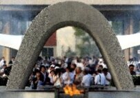 People pray before memorial to victims in Hiroshima's Peace Park on 6 August