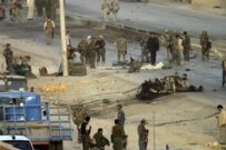 Afghan and coalition troops investigate the scene of today's suicide attack outside Kabul (RFE/RL)