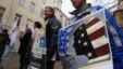 Demonstrators stand outside the Moscow office of the Golos election-monitoring NGO, with one sign branding the group a U.S. agent.
