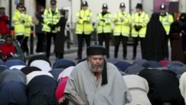 Radical Muslim cleric Abu Hamza al-Masri is seen leading prayers outside the North London Central Mosque in Finsbury Park, north London, in 2003.