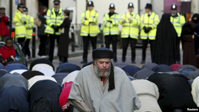 Radical Muslim cleric Abu Hamza al-Masri is seen leading prayers outside the North London Central Mosque in Finsbury Park, north London, in 2003.