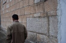 Iraq, A ma wallking next to a Yazidi Temple at northern part of Iraq, undated