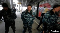 Russian special forces control access to a platform with a train that is reportedly transporting 30 Greenpeace at the Ladogsky railway station in St. Petersburg.