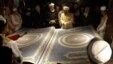 Afghan calligrapher Mohammad Sabir Khedri (center right) presents the biggest Koran in the world to Afghan officials during its inauguration ceremony in the Hakim Nasir Khosrow Balkhi library in Kabul on January 12.