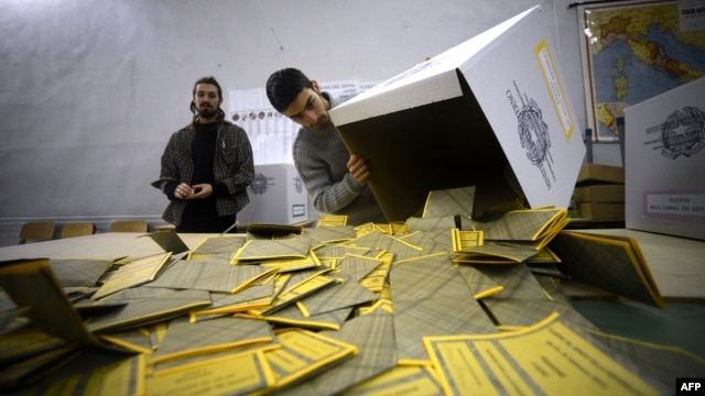 Workers open the ballots in a polling station in downtown Rome on February 25 after the second day of Italy's general elections.