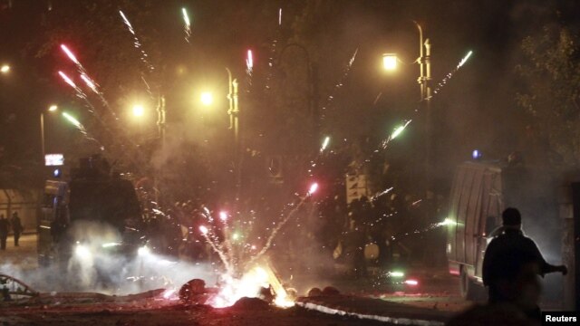 Fireworks explode as protesters angry over the anti-Islamic film clash with riot police along a road at Kornish El Nile, which leads to the U.S. Embassy in Cairo, on September 15.