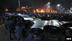 Armenian demonstrators clash with police during a mass protest outside the Russian consulate in Gyumri on January 15.