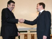 Georgian President Mikheil Saakashvili (left) shakes hands with Russian President Dmitry Medvedev at the CIS summit (epa)