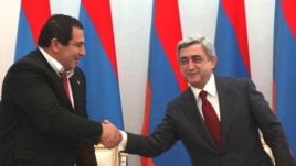 Armenia -- Prosperous Armenia Party leader Gagik Tsarukian (L) and President Serzh Sarkisian sign a joint declaration pledging support for the latter's reelection bid, 17Feb2011.