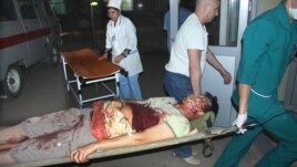 Lukpan Akhmedyarov is taken to hospital after being stabbed and shot in Oral on April 19.