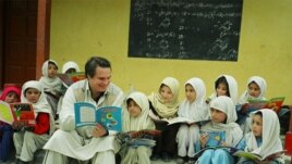 American writer Greg Mortenson with Gultori schoolchildren in Pakistan, undated.