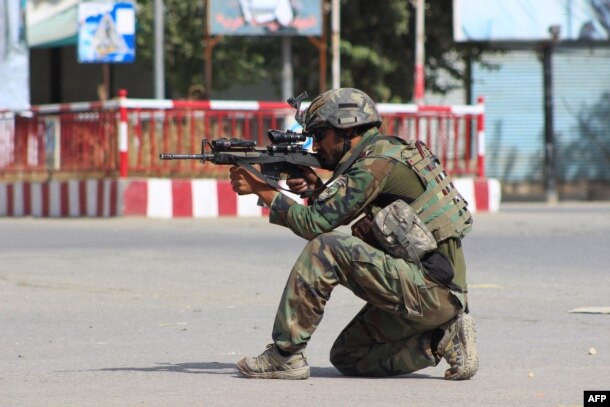 An Afghan National Army commando aims his weapon amid ongoing fighting between Taliban militants and Afghan security forces in Kunduz on October 5.