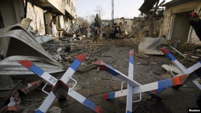 People inspect the site of one of the bomb blasts in Quetta that killed more than 80 people on January 10. 
