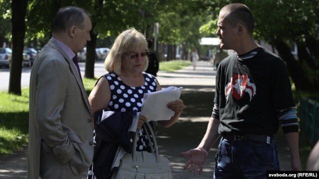 Political activist Vasil Parfyankou (right) outside the courtroom in Minsk on May 29, when he was ordered back to jail.